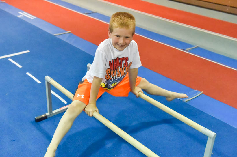 Boy straddling two bars