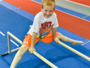 Boy straddling two bars